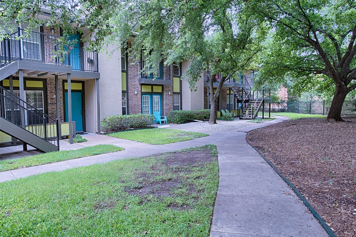 7685 Northcross Drive, Unit 426 Austin, TX 78757 - Photo 2 of 35 a front view of a house with garden