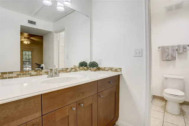 a bathroom with a sink vanity and a mirror