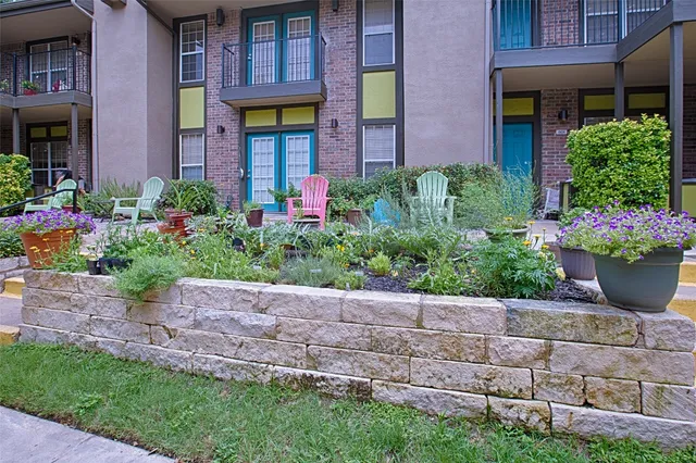 a view of a house with a garden and plants