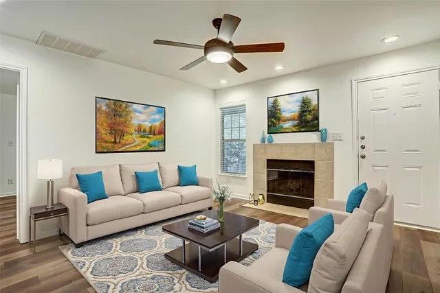 a living room with furniture a window and a fireplace
