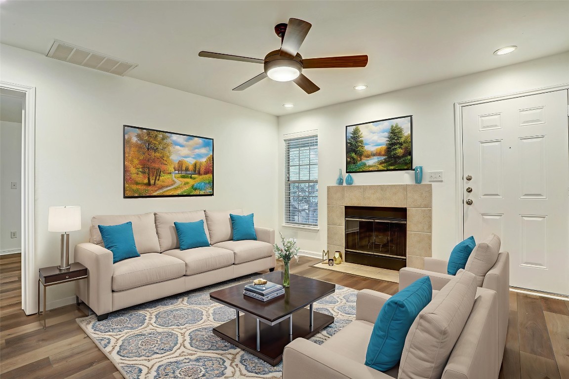 7685 Northcross Drive, Unit 426 Austin, TX 78757 - Photo 5 of 35 a living room with furniture a window and a fireplace