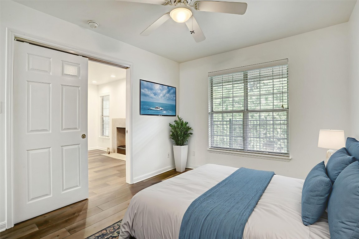 7685 Northcross Drive, Unit 426 Austin, TX 78757 - Photo 6 of 35 a spacious bedroom with a bed and a chandelier