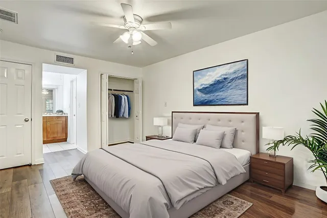 a bedroom with a large bed and a chandelier