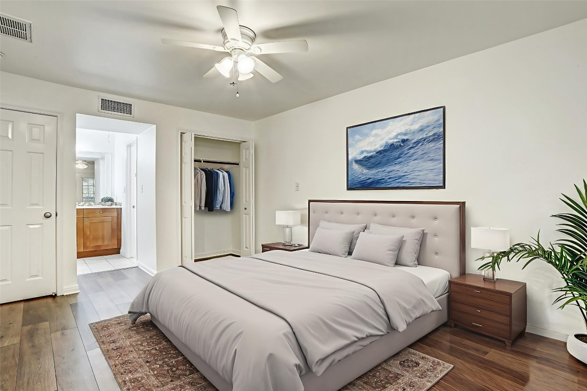 7685 Northcross Drive, Unit 426 Austin, TX 78757 - Photo 7 of 35 a bedroom with a large bed and a chandelier