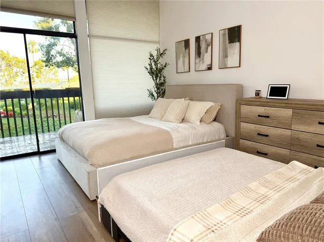 a bathroom with a double vanity sink a toilet a mirror and shower