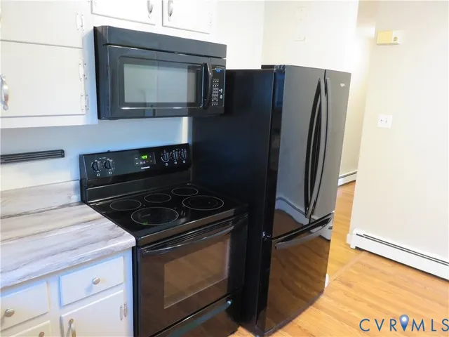 an empty room with a window and wooden floor