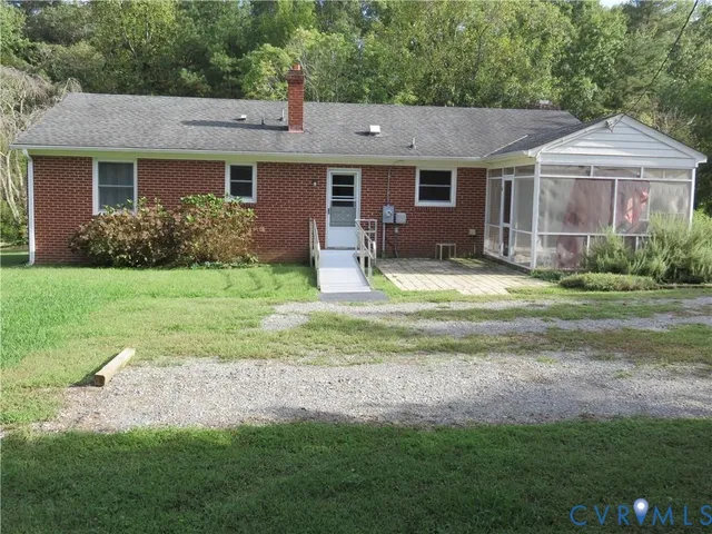a view of a house with a yard and sitting area