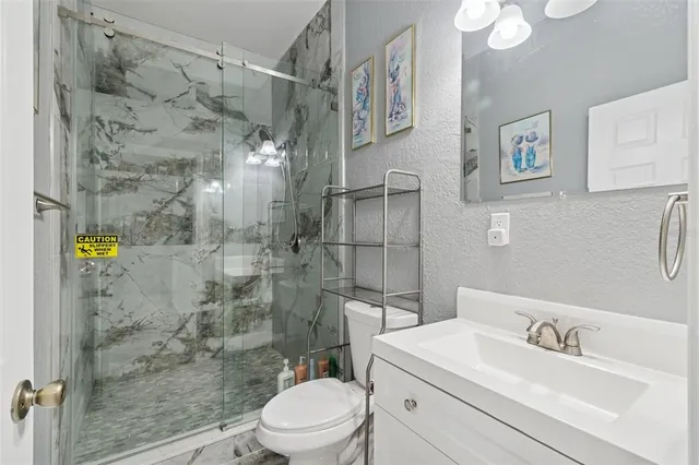 a kitchen with stainless steel appliances granite countertop a table and chairs in it