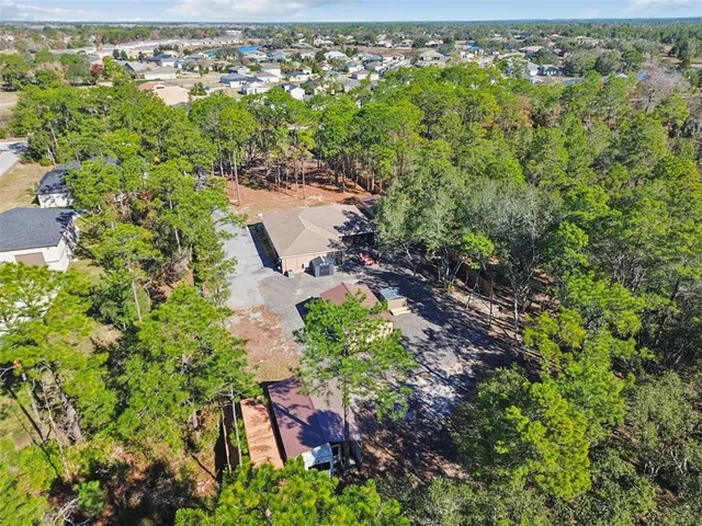an aerial view of a house with a yard and garden