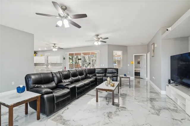 a living room with furniture and a chandelier