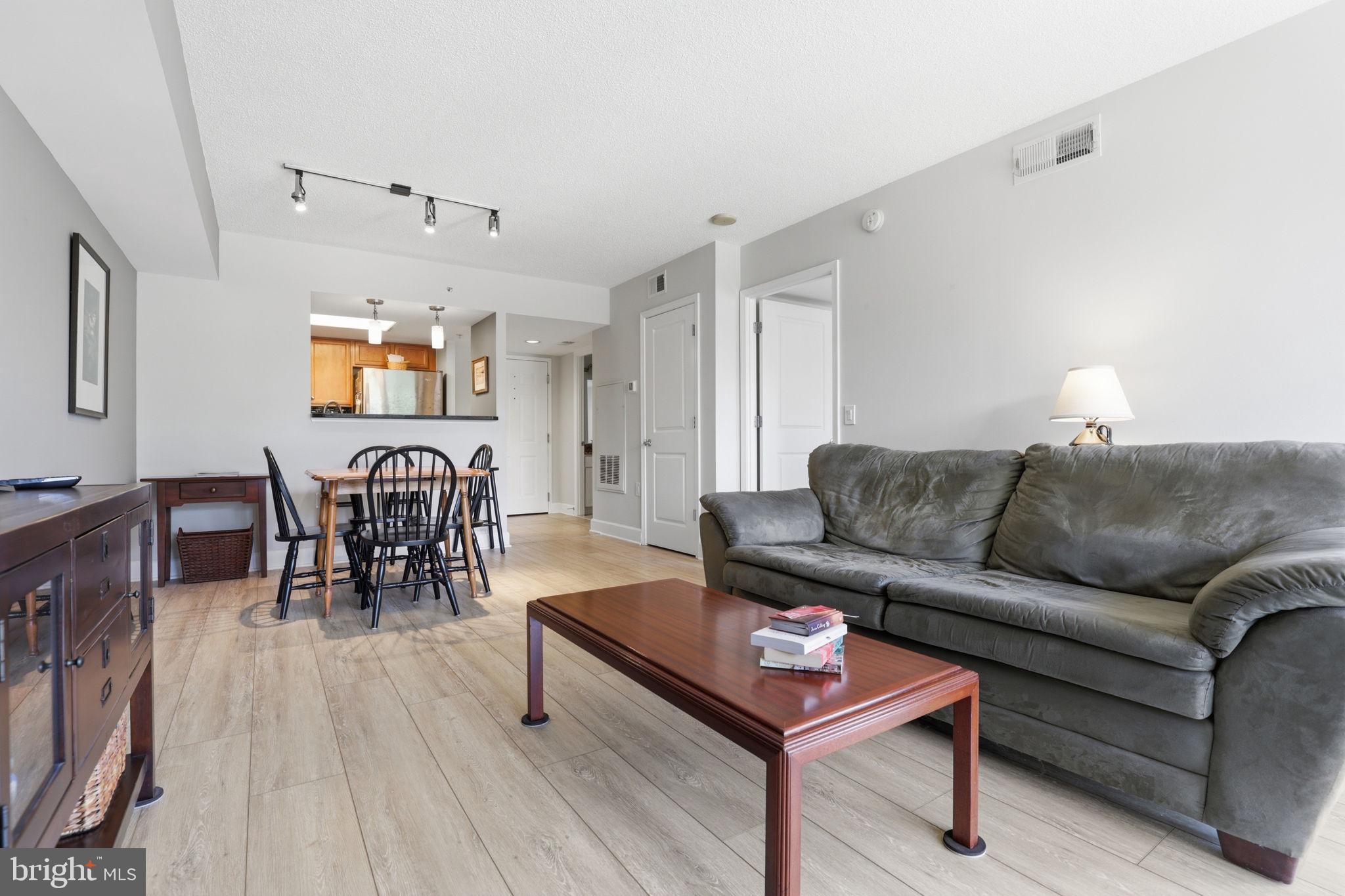 11800 Sunset Hills Road, Unit 218 Reston, VA 20190 - Photo 18 of 38 a living room with furniture and wooden floor