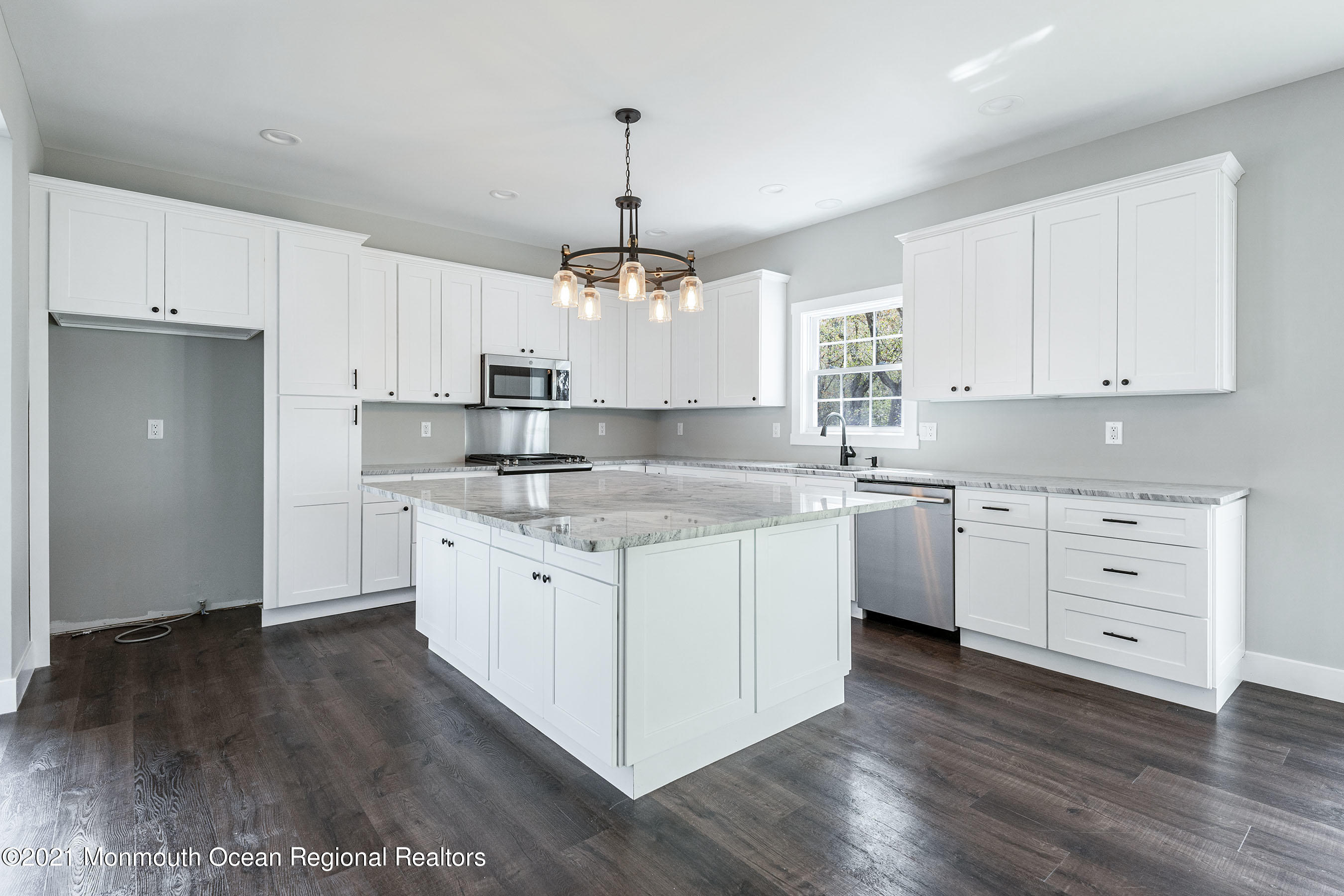 331 East Pleasant Grove Road Jackson, NJ 08527 - Photo 11 of 40 a kitchen with granite countertop white cabinets and white appliances