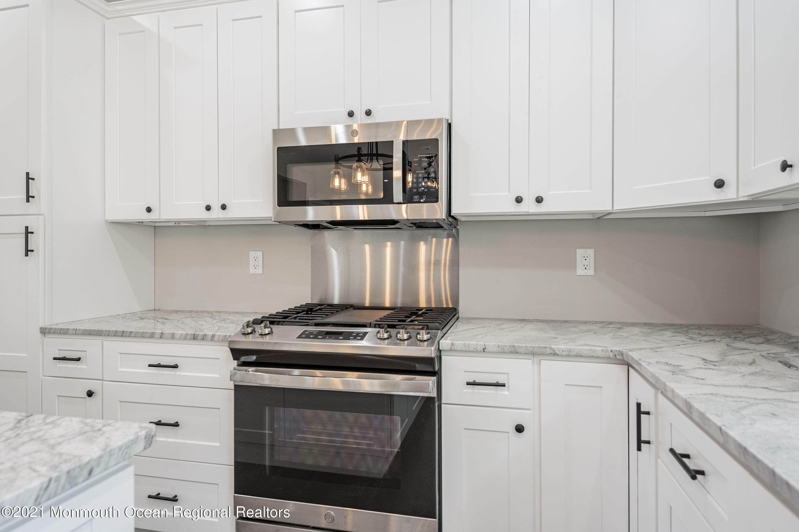 331 East Pleasant Grove Road Jackson, NJ 08527 - Photo 15 of 40 a kitchen with granite countertop white cabinets and appliances