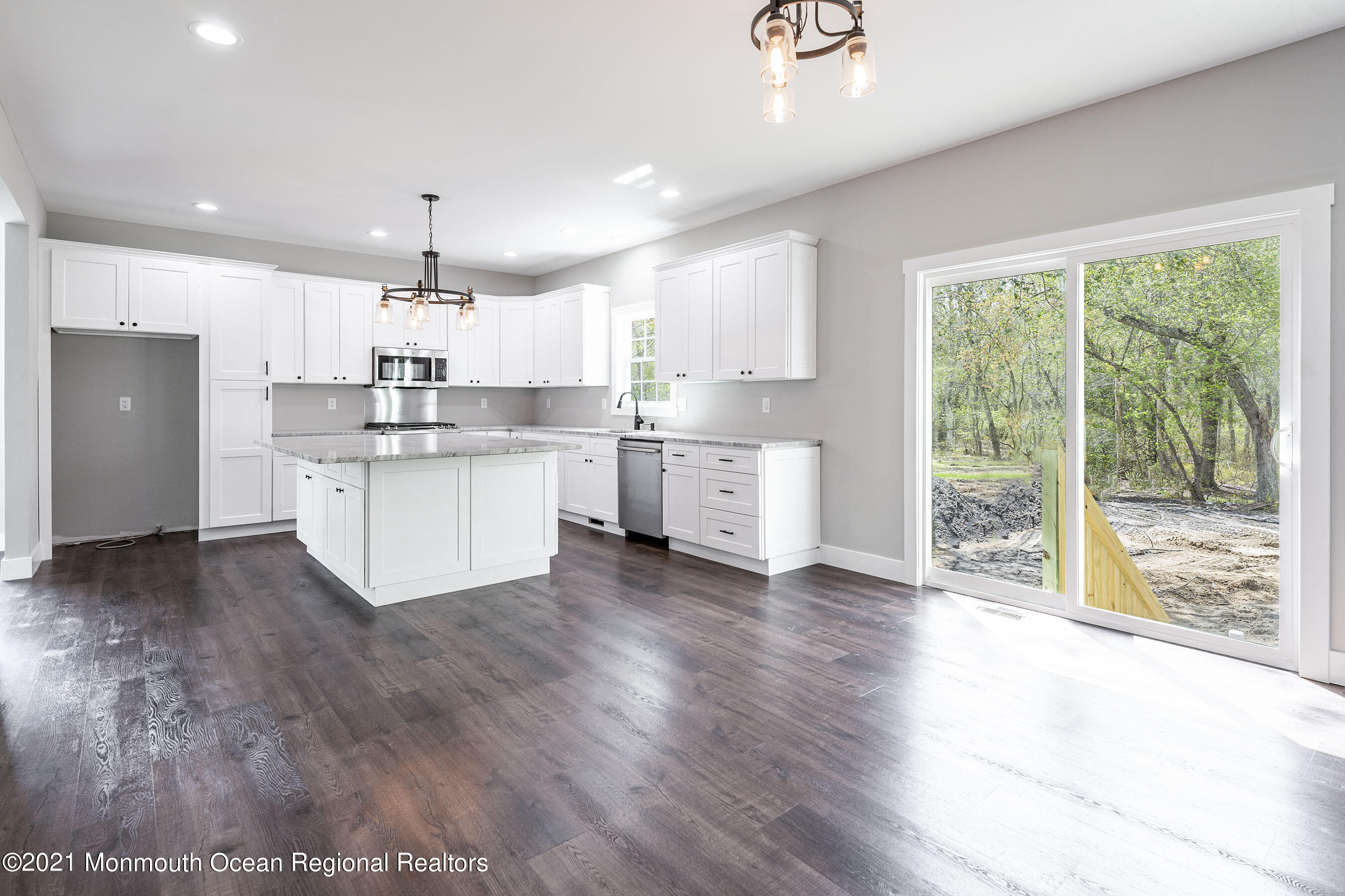 331 East Pleasant Grove Road Jackson, NJ 08527 - Photo 17 of 40 a kitchen with a stove a sink a center island and wooden floor