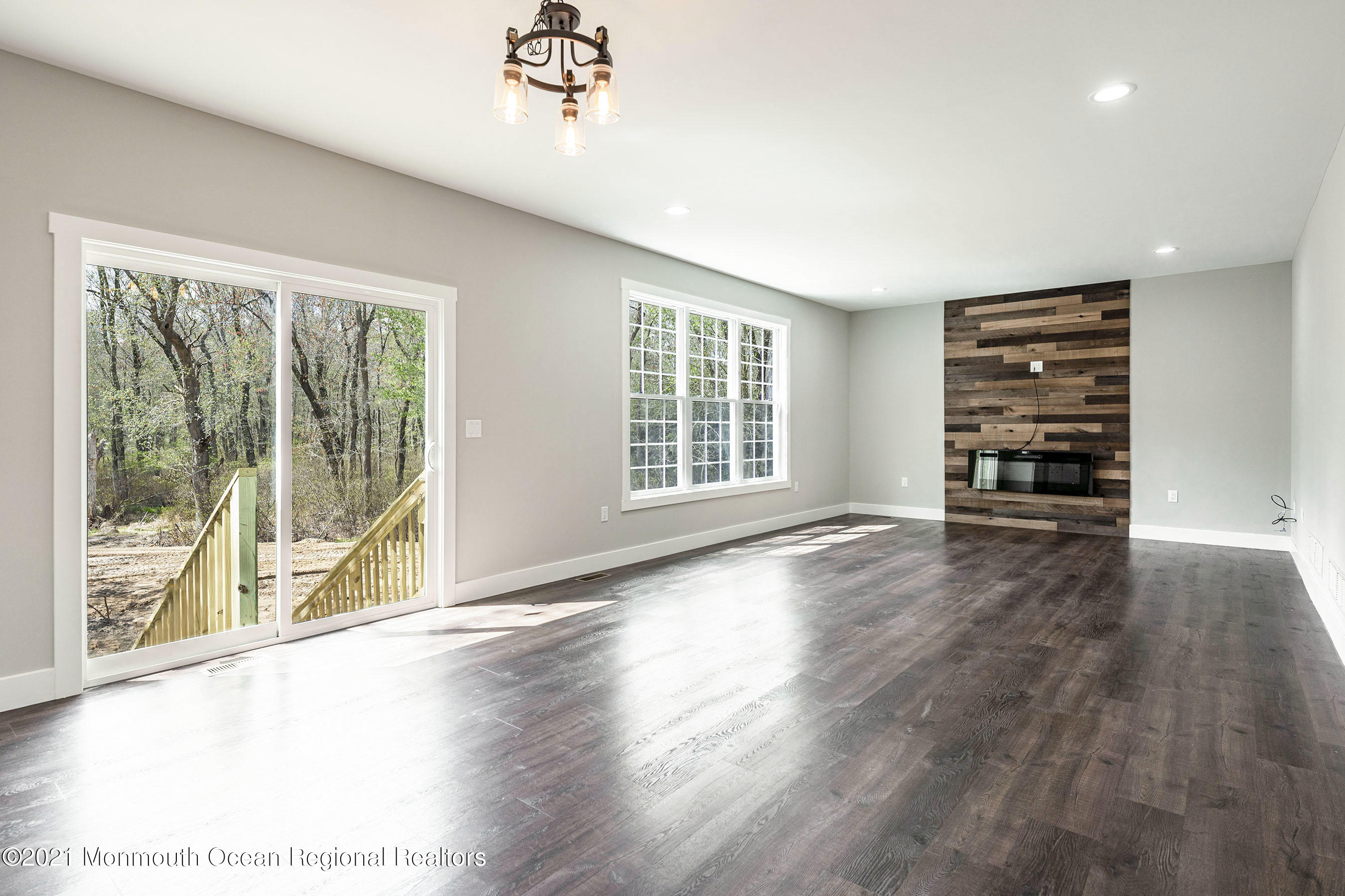 331 East Pleasant Grove Road Jackson, NJ 08527 - Photo 19 of 40 a view of an empty room with a window and wooden floor