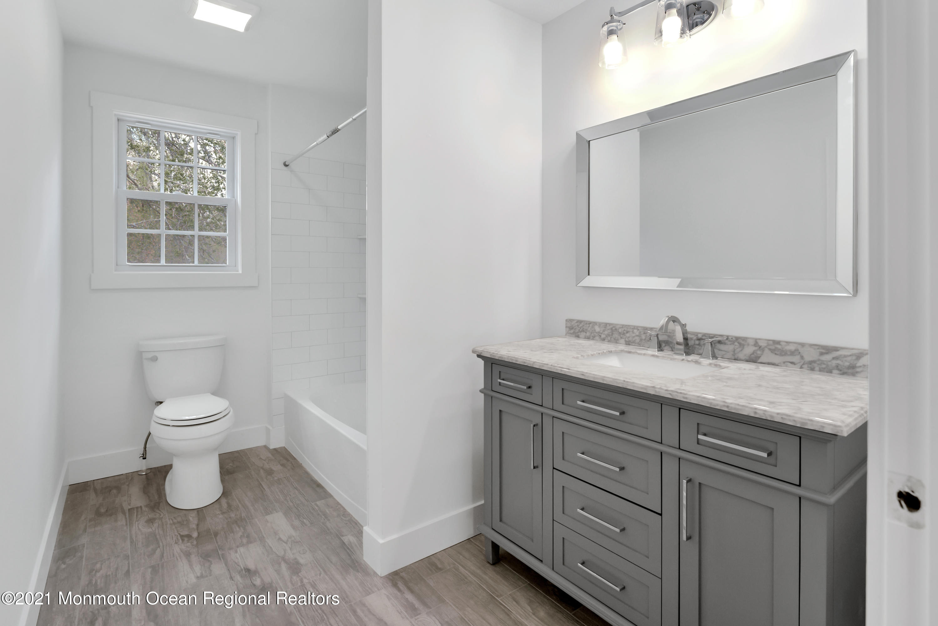 331 East Pleasant Grove Road Jackson, NJ 08527 - Photo 32 of 40 a bathroom with a granite countertop sink a toilet and a mirror
