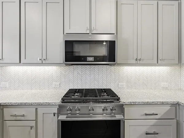 a stove top oven sitting inside of a kitchen