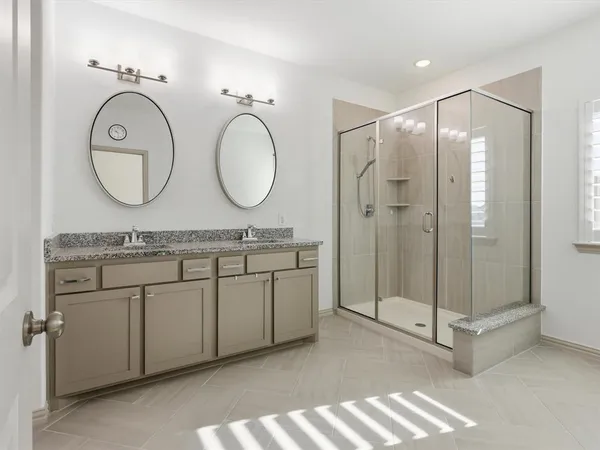 a bathroom with a double vanity sink and a mirror