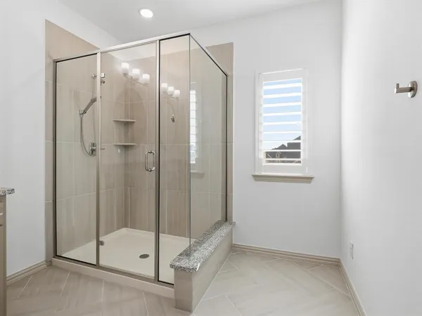 a bathroom that has a glass shower door
