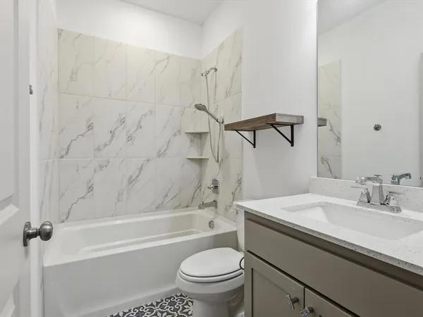 a bathroom with a sink a toilet and a bathtub