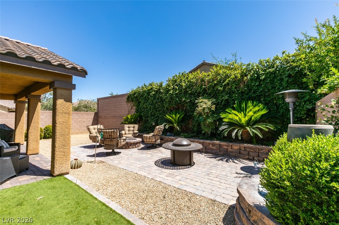 7375 Campbell Ranch Avenue Las Vegas, NV 89179 - Photo 33 of 45 Entertain guests in this spacious outdoor living area with a covered patio and a cozy fire pit.