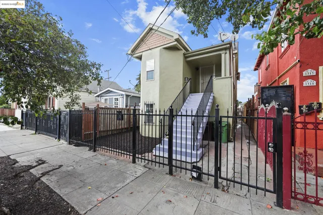 a view of a house with iron fence