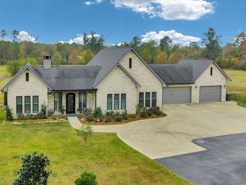 a front view of house with yard and green space