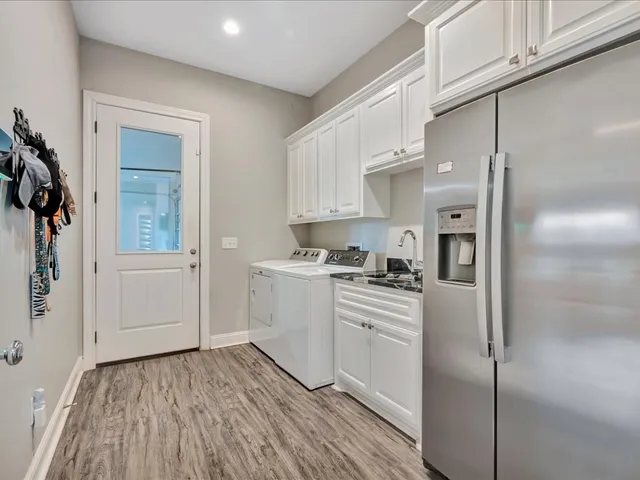 a kitchen with white cabinets and white appliances