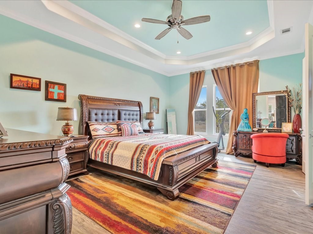 104 Wheeler Road Lufkin, TX 75901 - Photo 19 of 50 a spacious bedroom with a bed and wooden floor