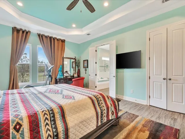 a bedroom with a bed and a flat screen tv