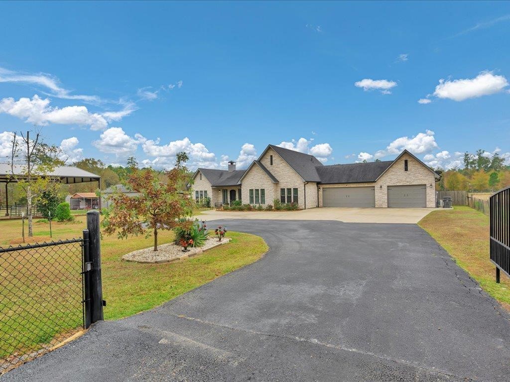 104 Wheeler Road Lufkin, TX 75901 - Photo 2 of 50 a front view of a house with a yard and garage