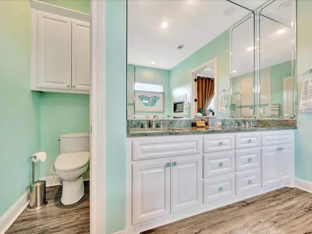 a bathroom with a toilet sink and mirror