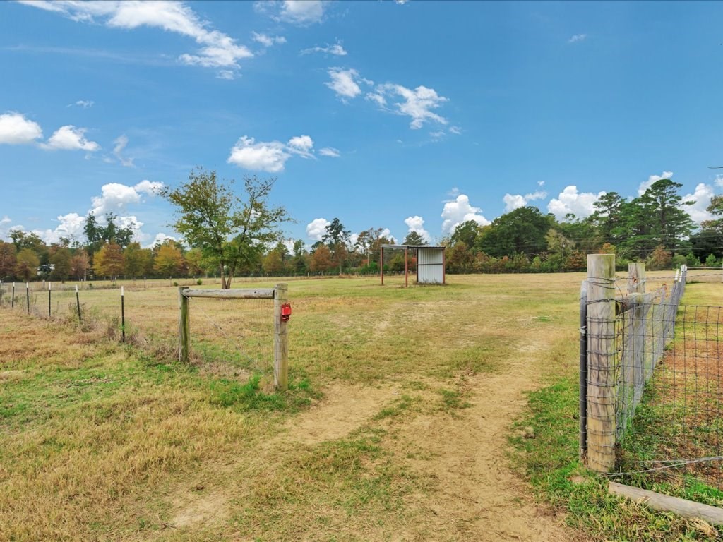 104 Wheeler Road Lufkin, TX 75901 - Photo 33 of 50 a view of a lake with a yard