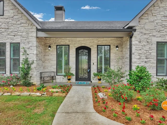 a front view of a house with garden