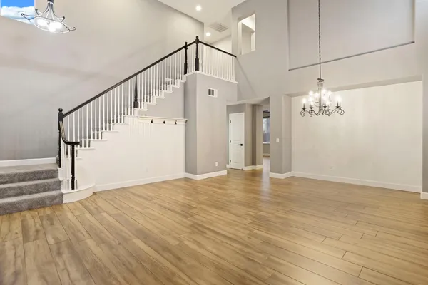 a view of a room with wooden floor and staircase