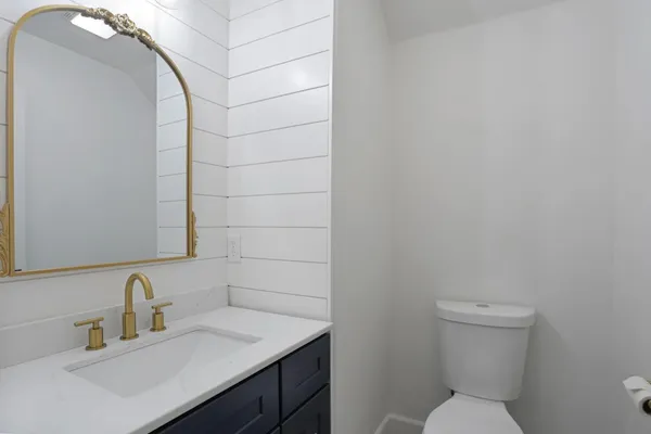 a bathroom with a toilet sink and mirror