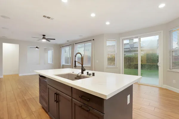 a kitchen with stainless steel appliances a stove refrigerator and cabinets
