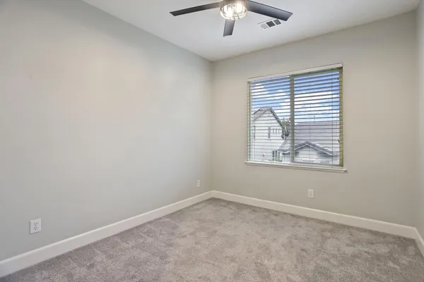 a hallway view with wooden floor and cabinets