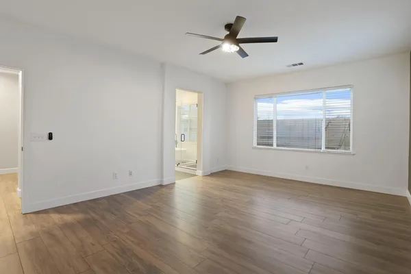 a bathroom with double vanity sinks a toilet a mirror and shower