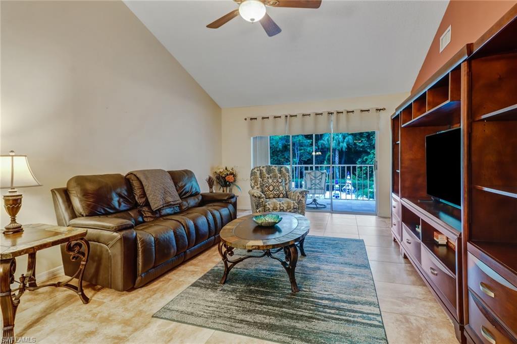5675 Whitaker Road, Unit B202 Naples, FL 34112 - Photo 3 of 26 a living room with furniture and a flat screen tv