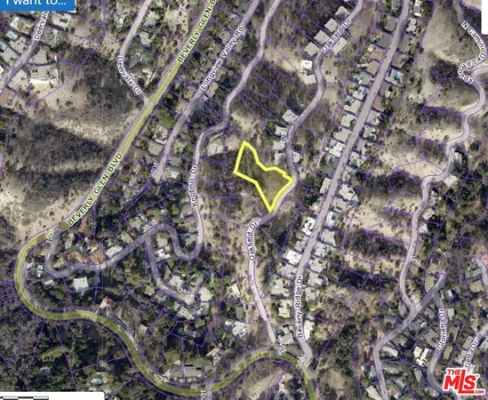 a aerial view of a house with a yard and wooden fence