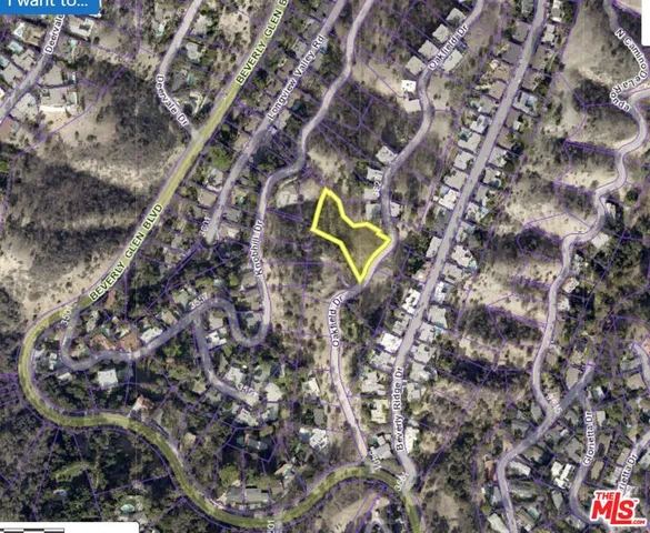 a aerial view of a house with a yard and wooden fence