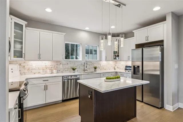 a kitchen with a sink stove and refrigerator