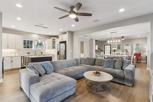 a living room with furniture and kitchen view