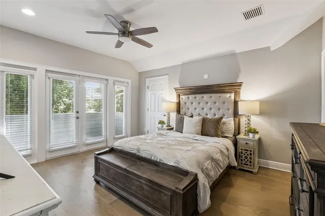 a bedroom with a bed and large window