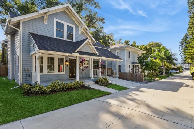 a living room with furniture a fireplace and a large window