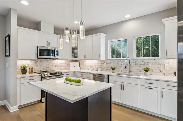 a kitchen with a sink stove and cabinets