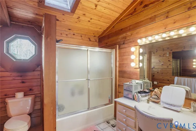 a bathroom with a toilet sink a mirror and shower