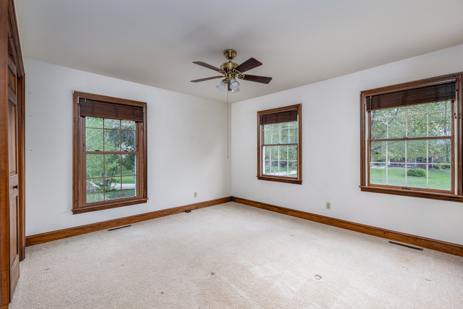 3094 East 1888th Road Ottawa, IL 61350 - Photo 21 of 43 an empty room with windows and ceiling fan view