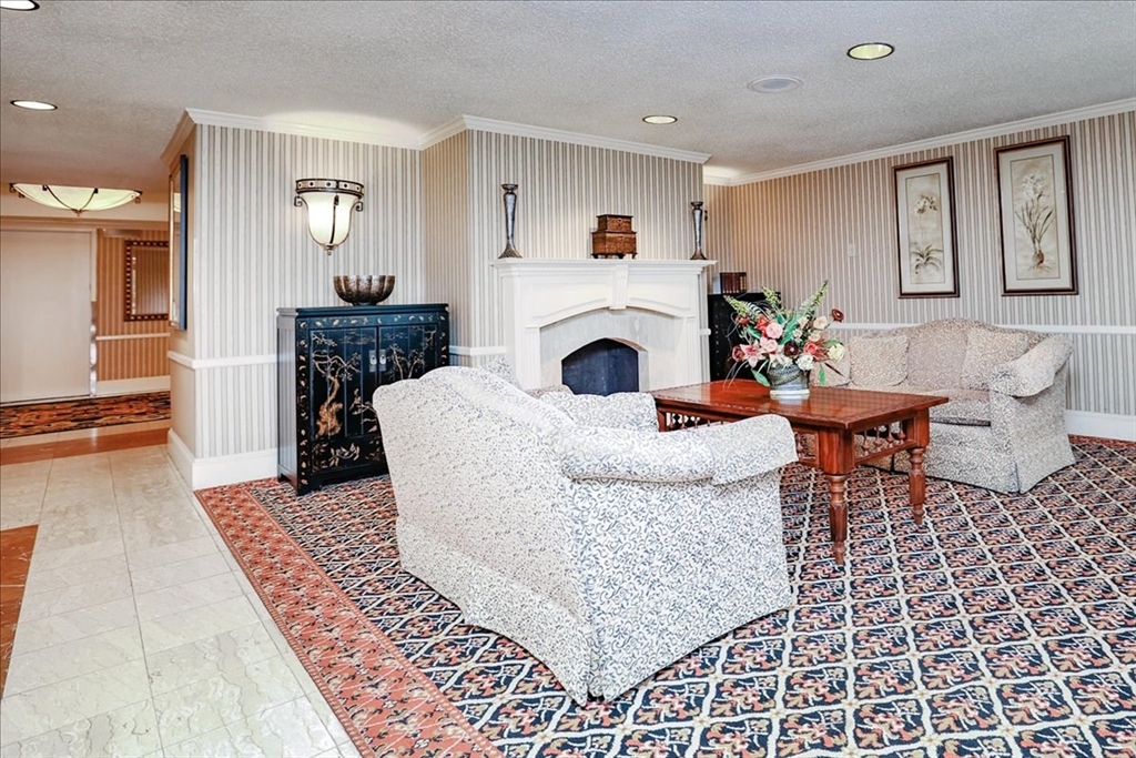 1004 Paradise Road, Unit 1L Swampscott, MA 01907 - Photo 11 of 28 a living room with furniture and a fireplace